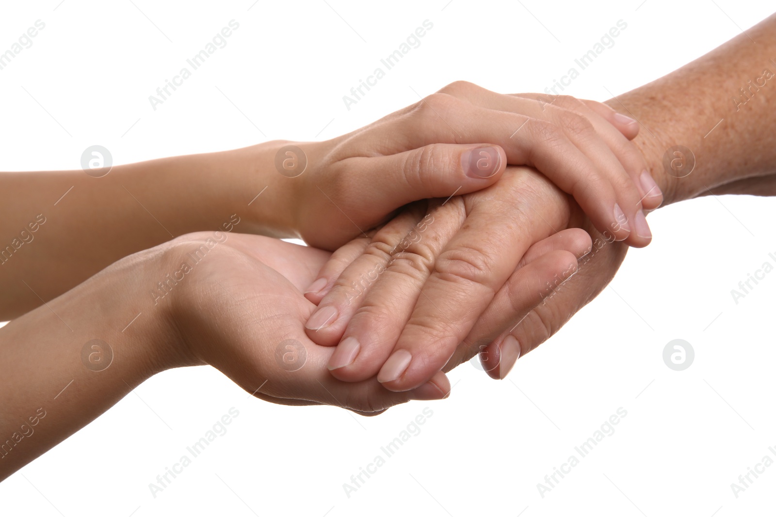 Photo of Young and elderly women holding hands together on white background, closeup