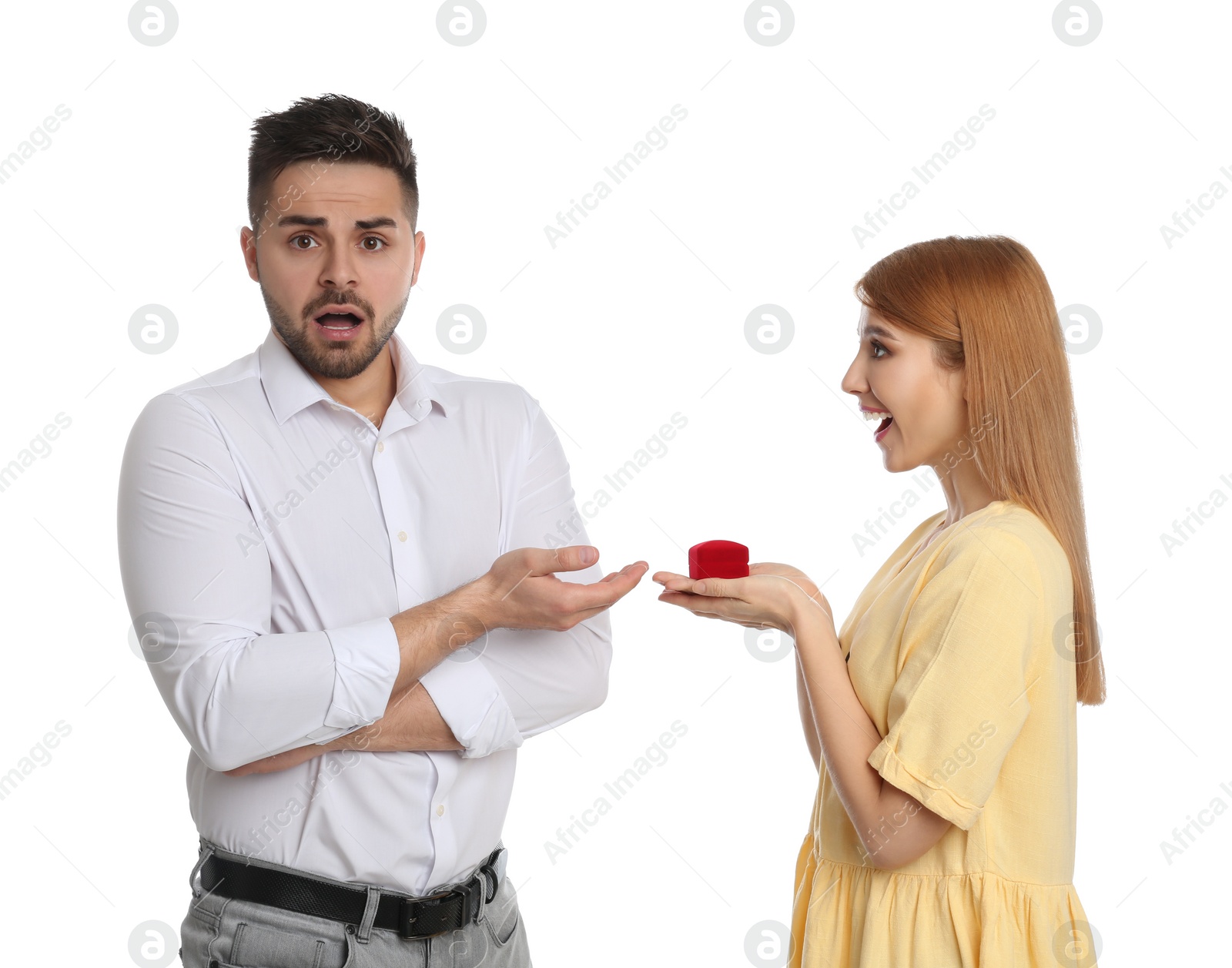 Photo of Young woman with engagement ring making marriage proposal to her boyfriend on white background