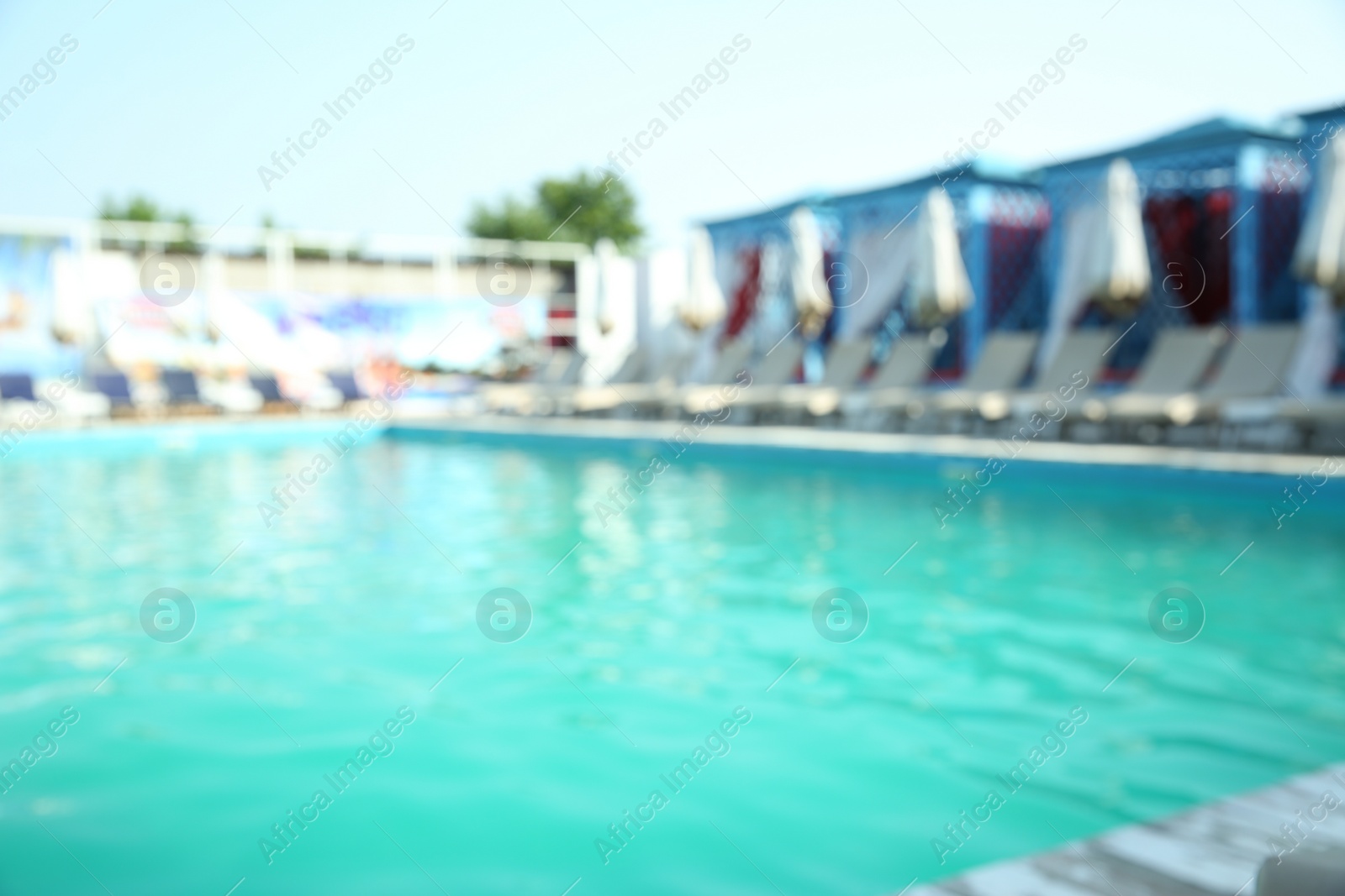 Photo of Blurred view of modern outdoor swimming pool on sunny day