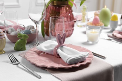 Festive table setting with napkin ring in shape of bunny ears. Easter celebration