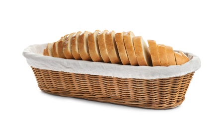 Photo of Sliced tasty fresh bread in wicker basket on white background