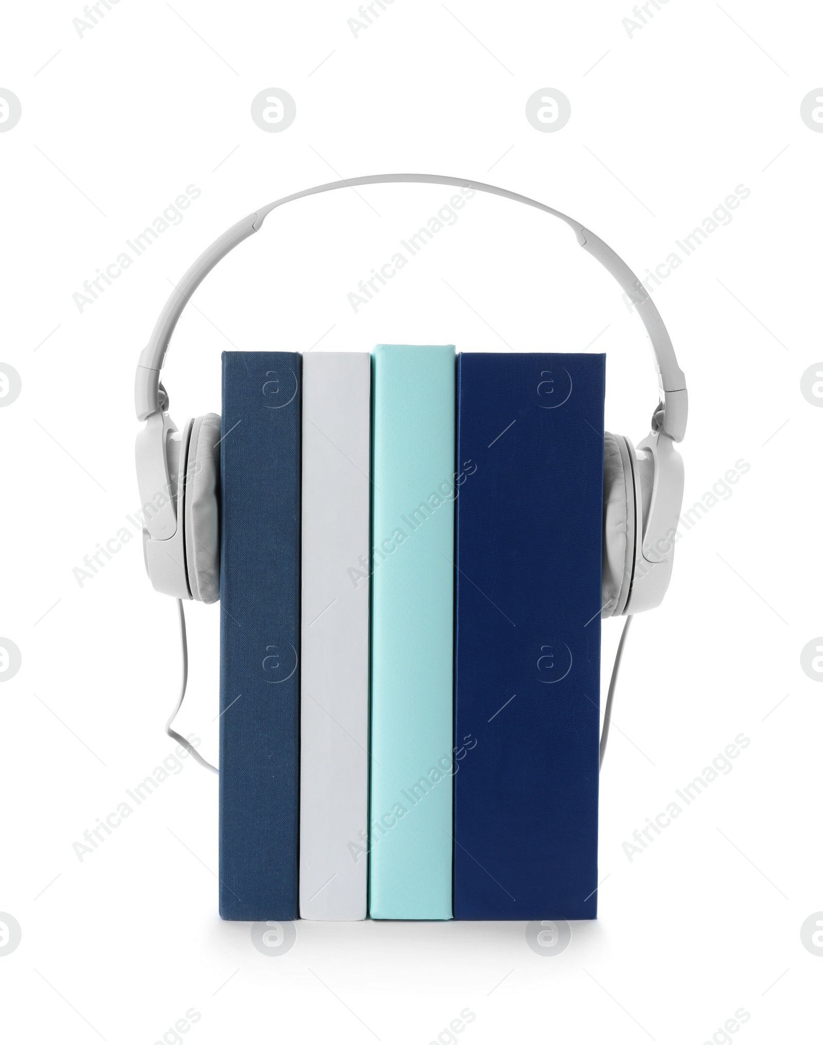 Photo of Modern headphones with hardcover books on white background