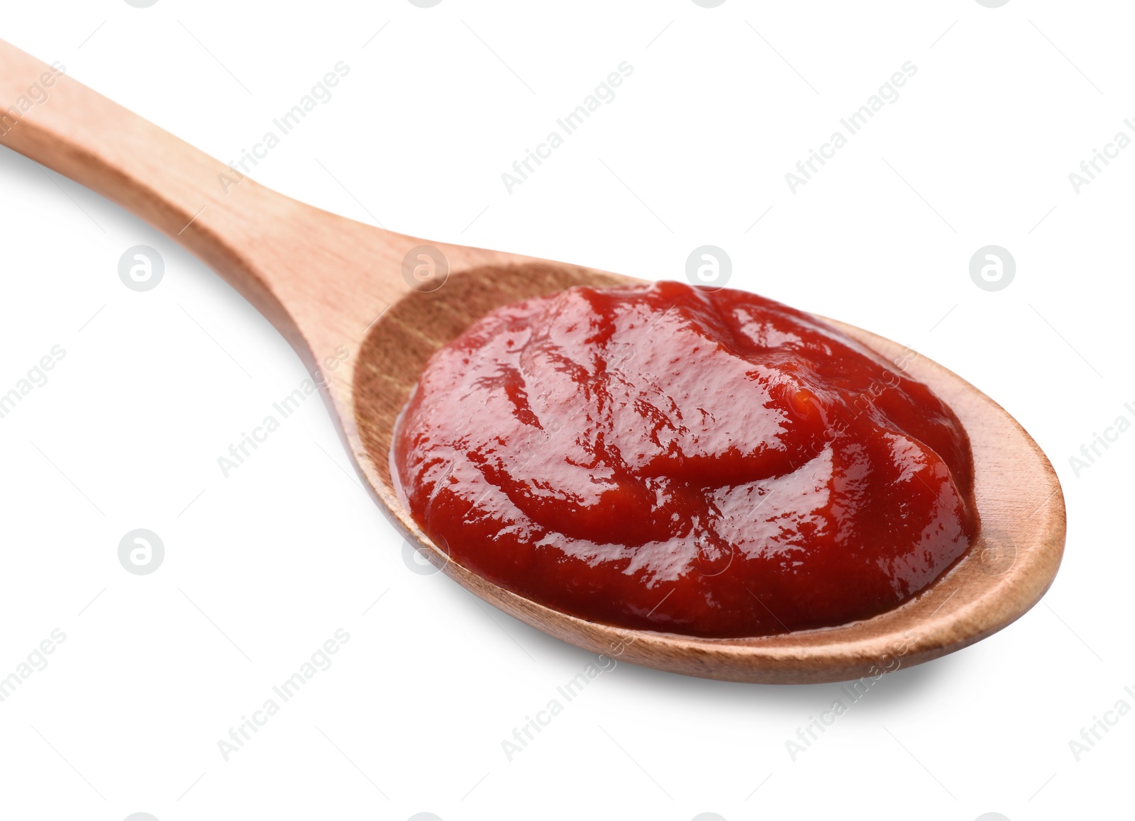 Photo of Tasty ketchup in wooden spoon isolated on white, closeup