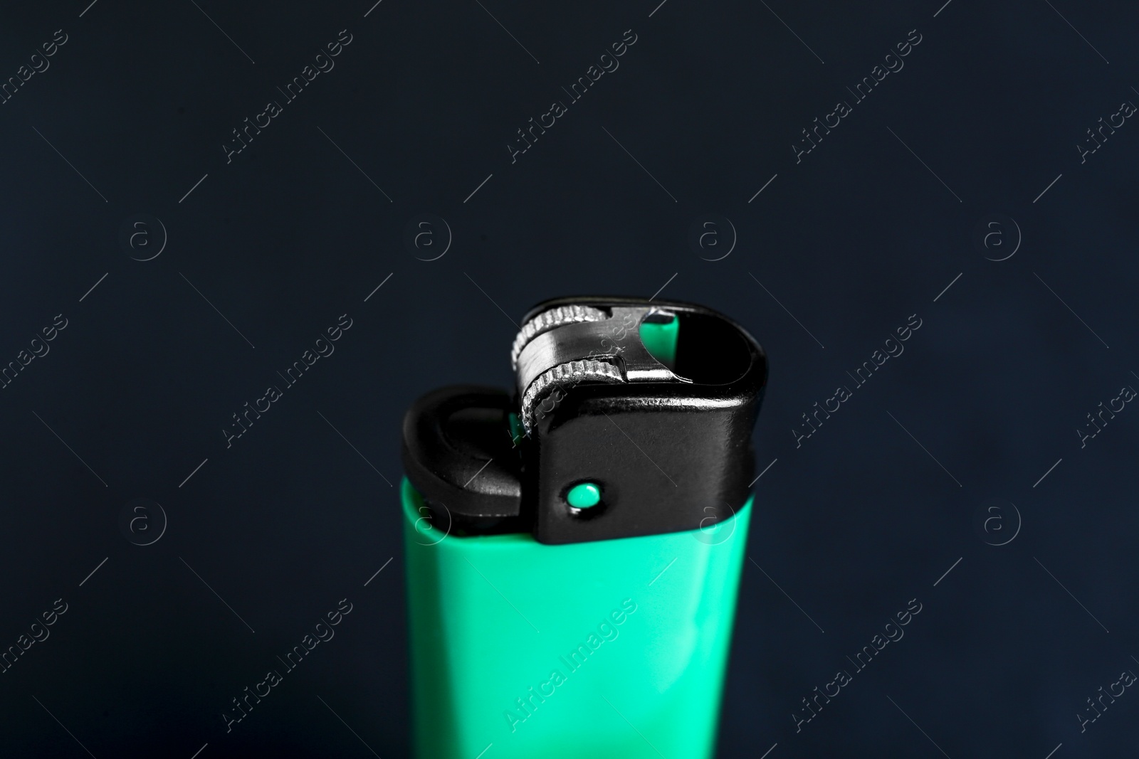 Photo of Stylish small pocket lighter on black background, closeup