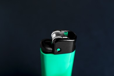 Stylish small pocket lighter on black background, closeup