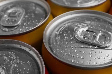 Photo of Energy drinks in wet cans, closeup. Functional beverage