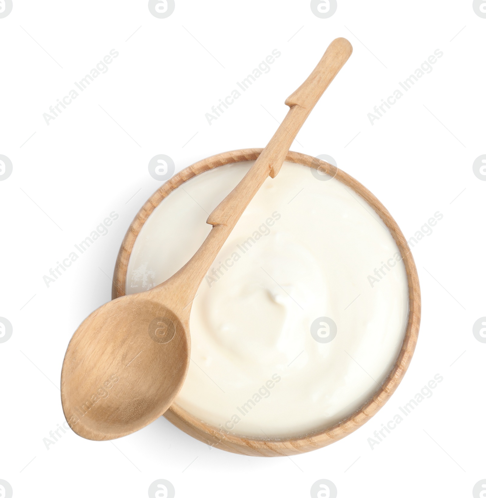 Photo of Tasty organic yogurt in wooden bowl and spoon isolated on white, top view