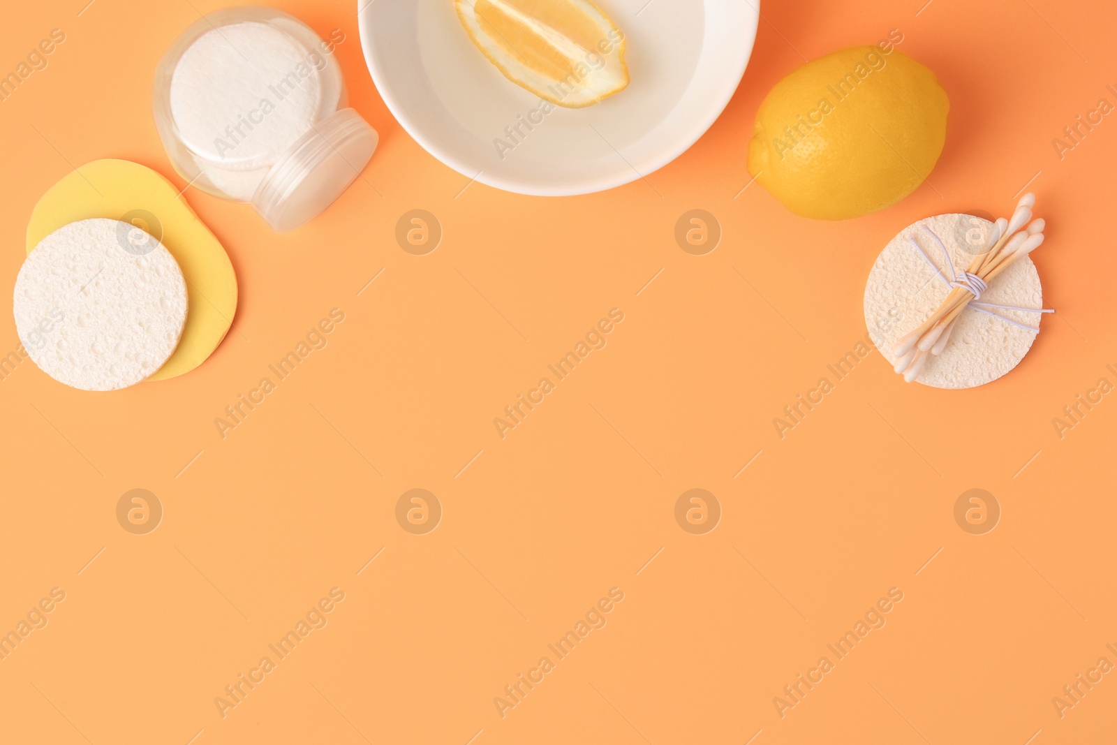 Photo of Lemon face wash. Fresh citrus fruits and personal care products on pale orange background, flat lay with space for text