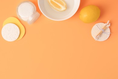 Photo of Lemon face wash. Fresh citrus fruits and personal care products on pale orange background, flat lay with space for text