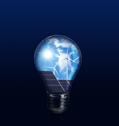Image of Alternative energy source. Light bulb with solar panels and wind turbines on blue background 