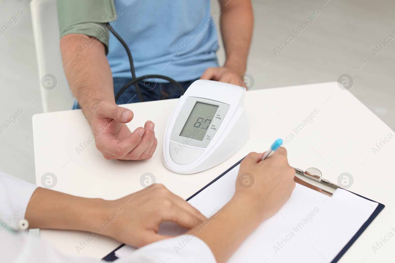 Photo of Doctor checking patient's blood pressure in hospital