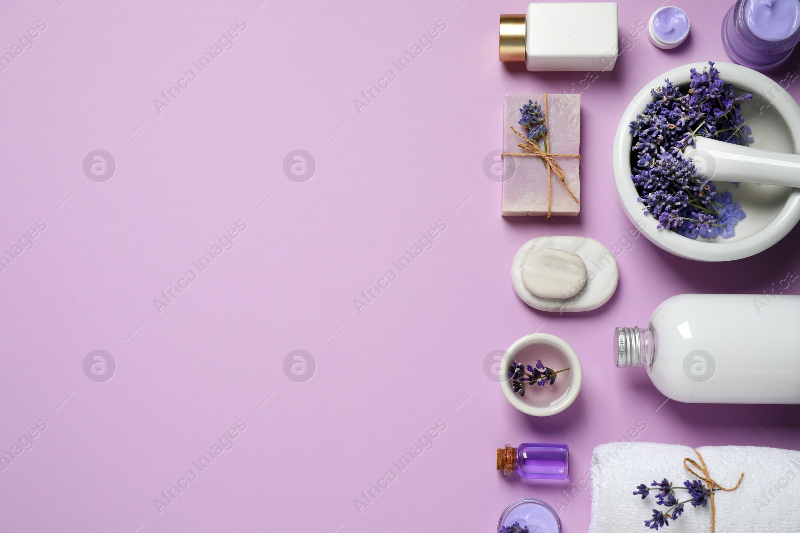 Photo of Cosmetic products and lavender flowers on lilac background, flat lay. Space for text