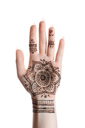 Photo of Woman with beautiful henna tattoo on hand against white background, closeup. Traditional mehndi