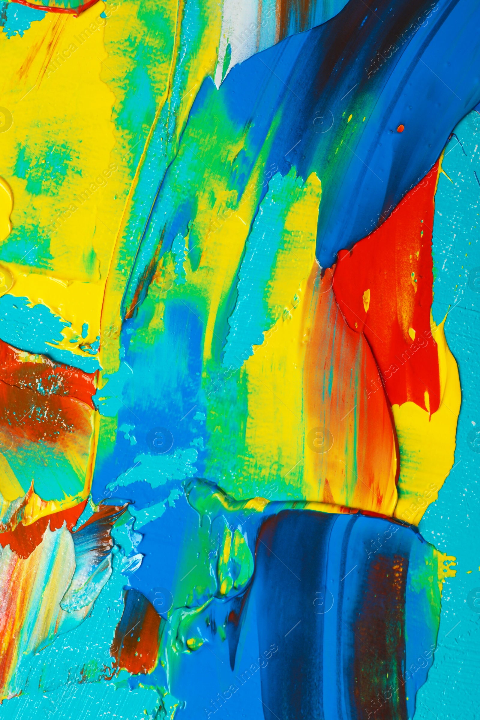 Photo of Closeup view of artist's palette with mixed bright paints as background