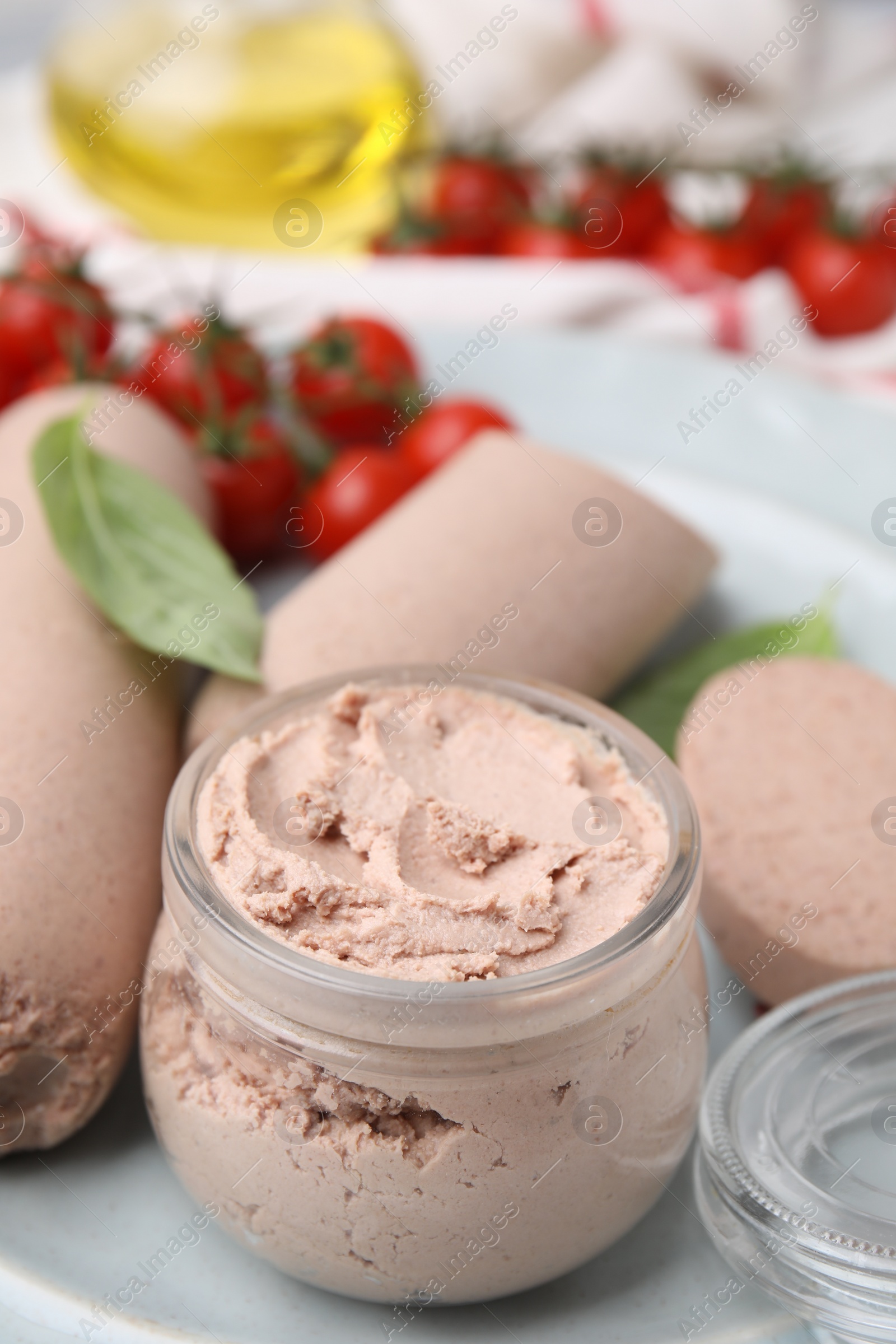 Photo of Delicious liver sausages and paste on table, closeup view