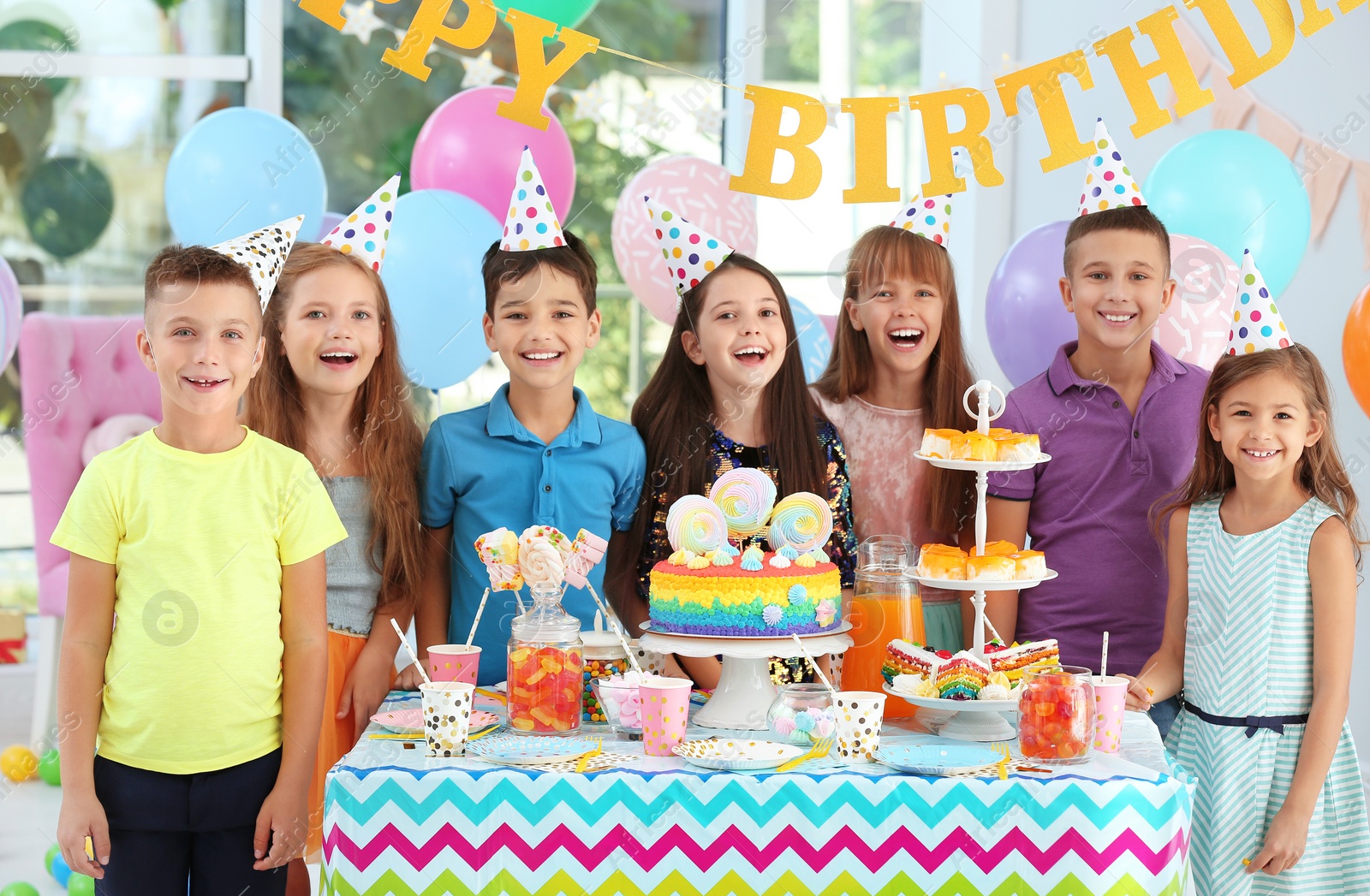 Photo of Happy children at birthday party in decorated room