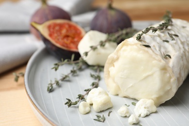 Photo of Delicious goat cheese with thyme on plate, closeup