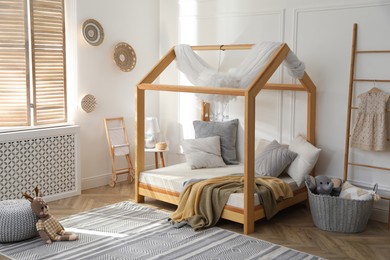 Stylish child room interior with house bed