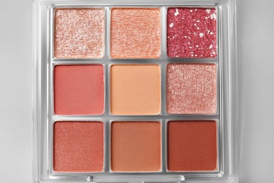 Beautiful eyeshadow palette on light gray background, top view. Professional cosmetic product
