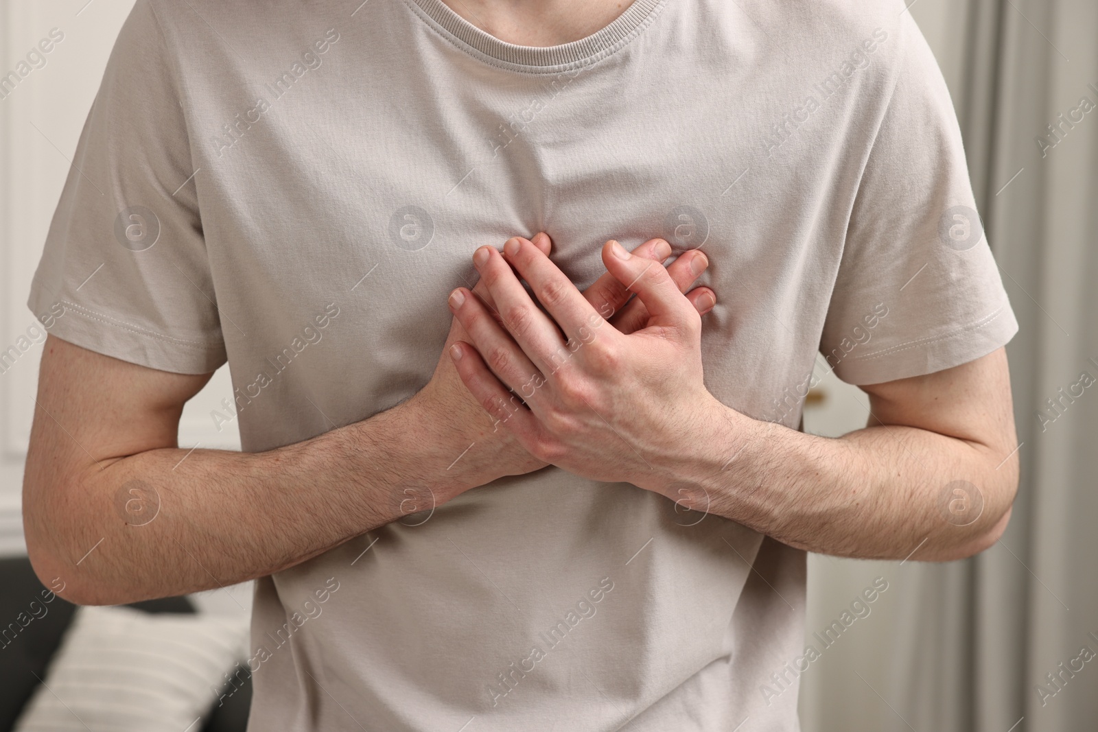 Photo of Man suffering from heart hurt at home, closeup