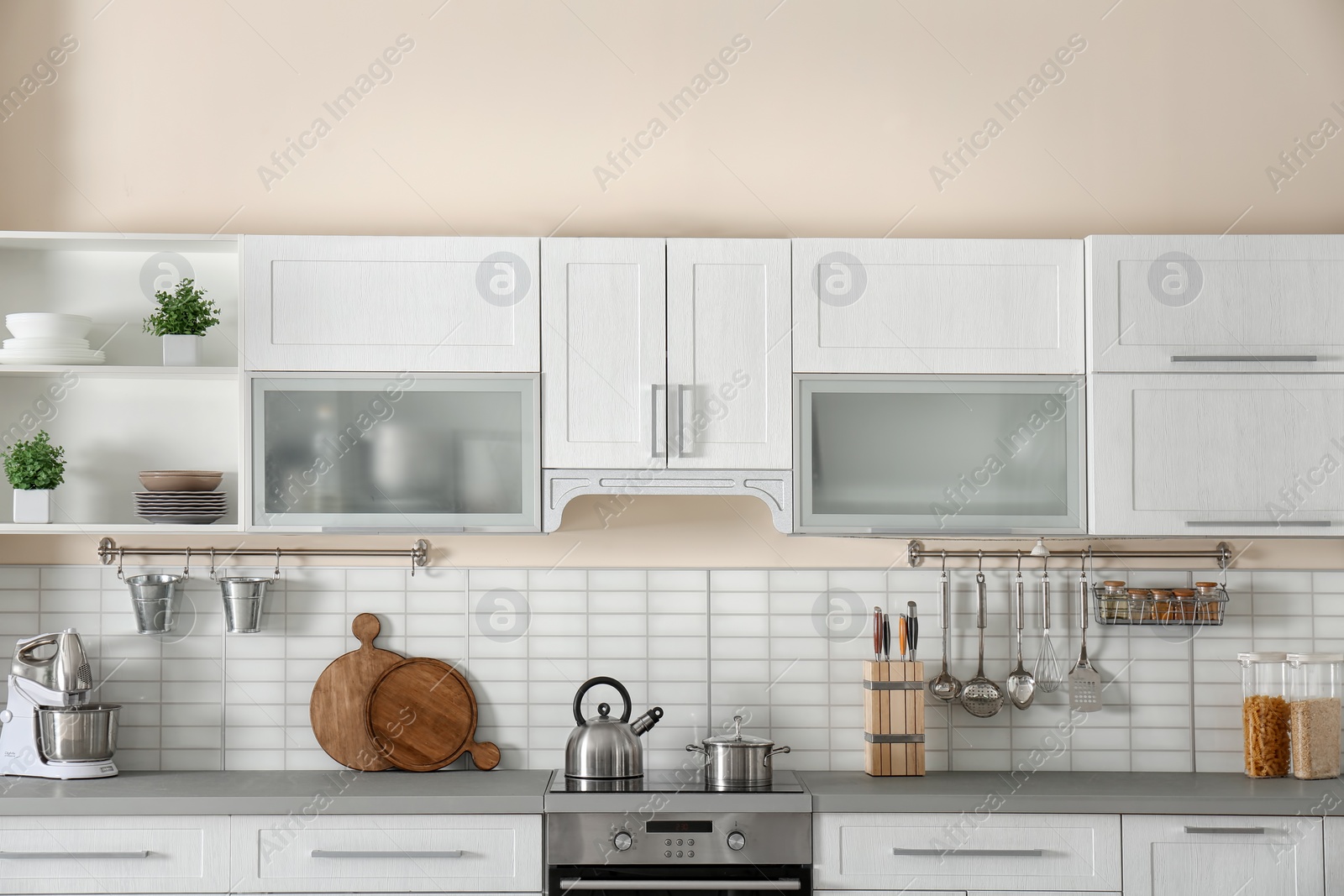 Photo of Stylish kitchen interior with new furniture and utensils