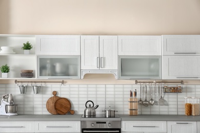 Stylish kitchen interior with new furniture and utensils