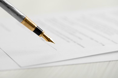 Photo of Signing document with fountain pen, closeup. Notary services