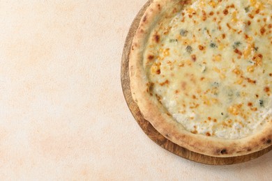 Photo of Delicious cheese pizza on beige textured table, top view. Space for text