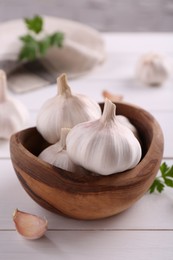 Photo of Fresh garlic on white wooden table, closeup