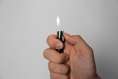 Photo of Man holding lighter on white background, closeup