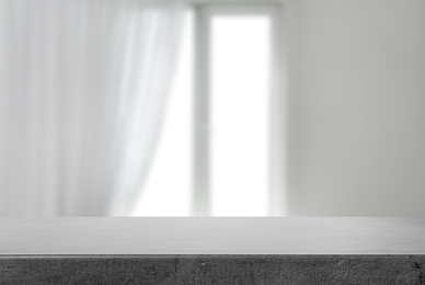 Image of Empty grey stone surface and blurred view of modern window 