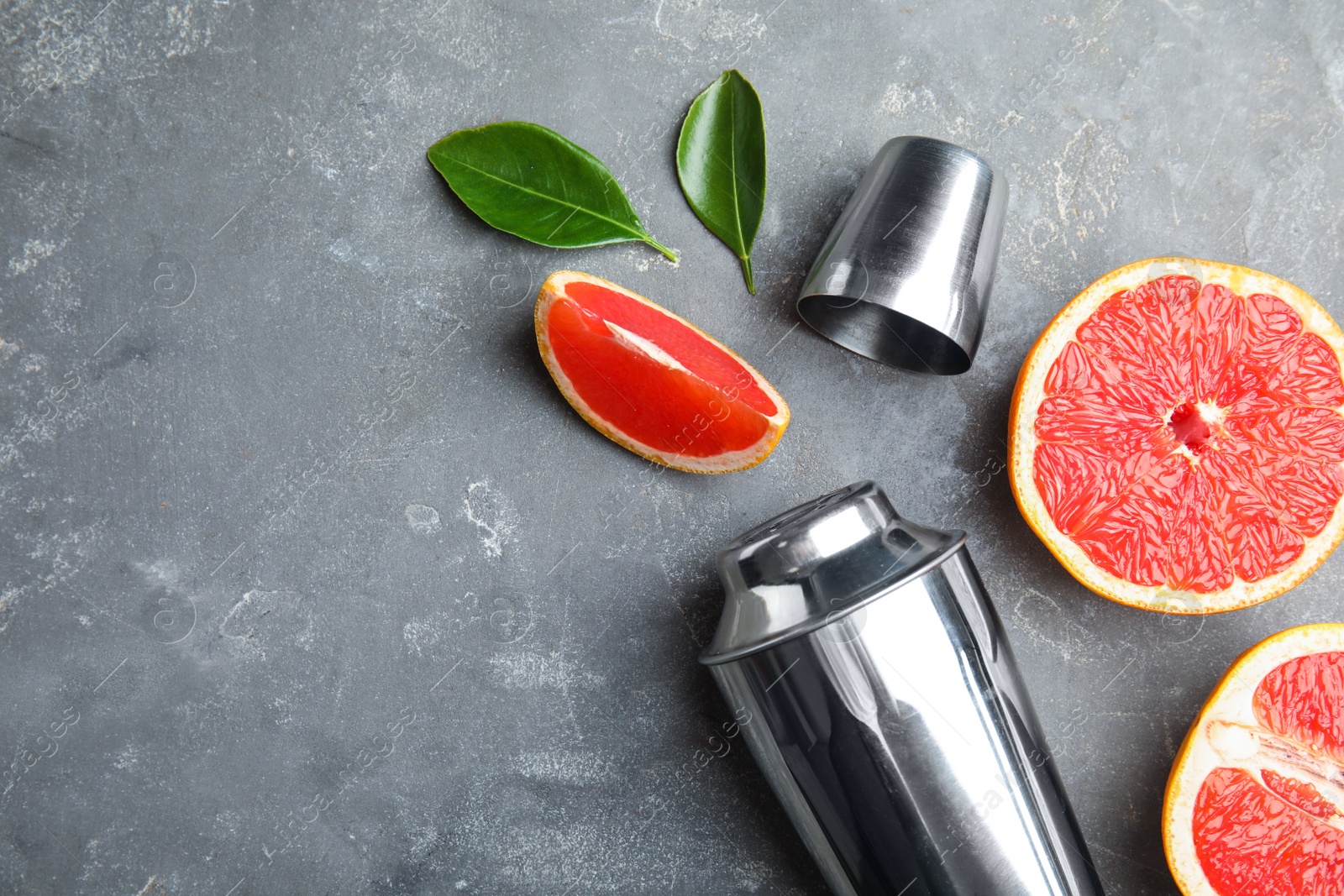 Photo of Flat lay composition with grapefruits and space for text on grey background