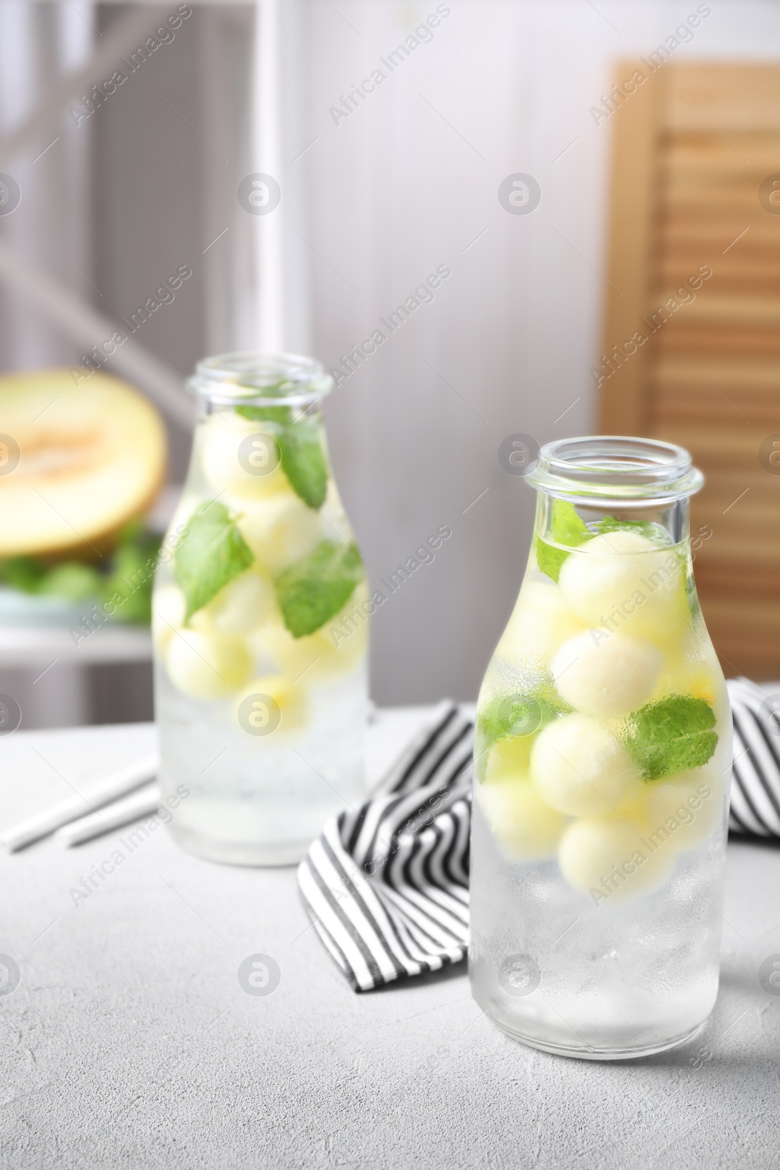 Photo of Tasty melon ball drink on light grey table indoors