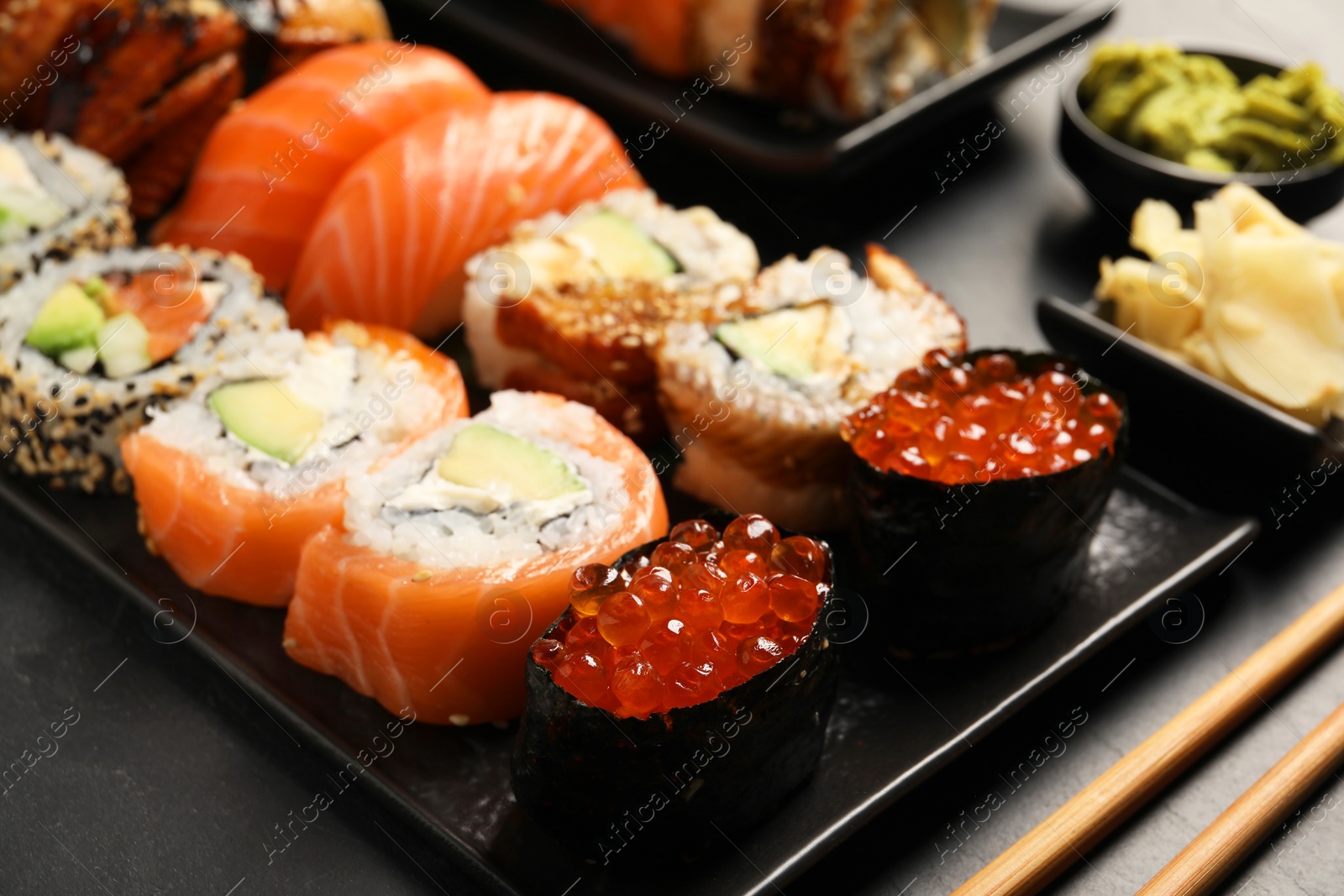 Photo of Set of delicious sushi rolls on table, closeup