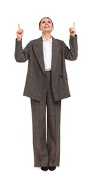 Beautiful businesswoman in suit pointing at something on white background