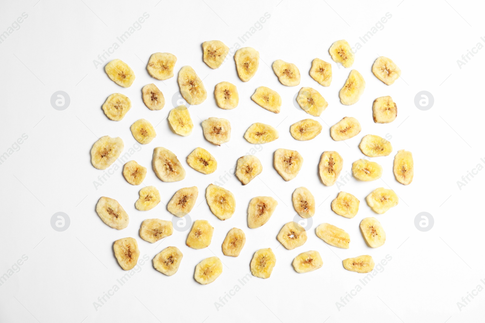 Photo of Flat lay composition with banana slices on  white background. Dried fruit as healthy snack