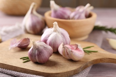 Photo of Bulbs and cloves of fresh garlic on table, closeup