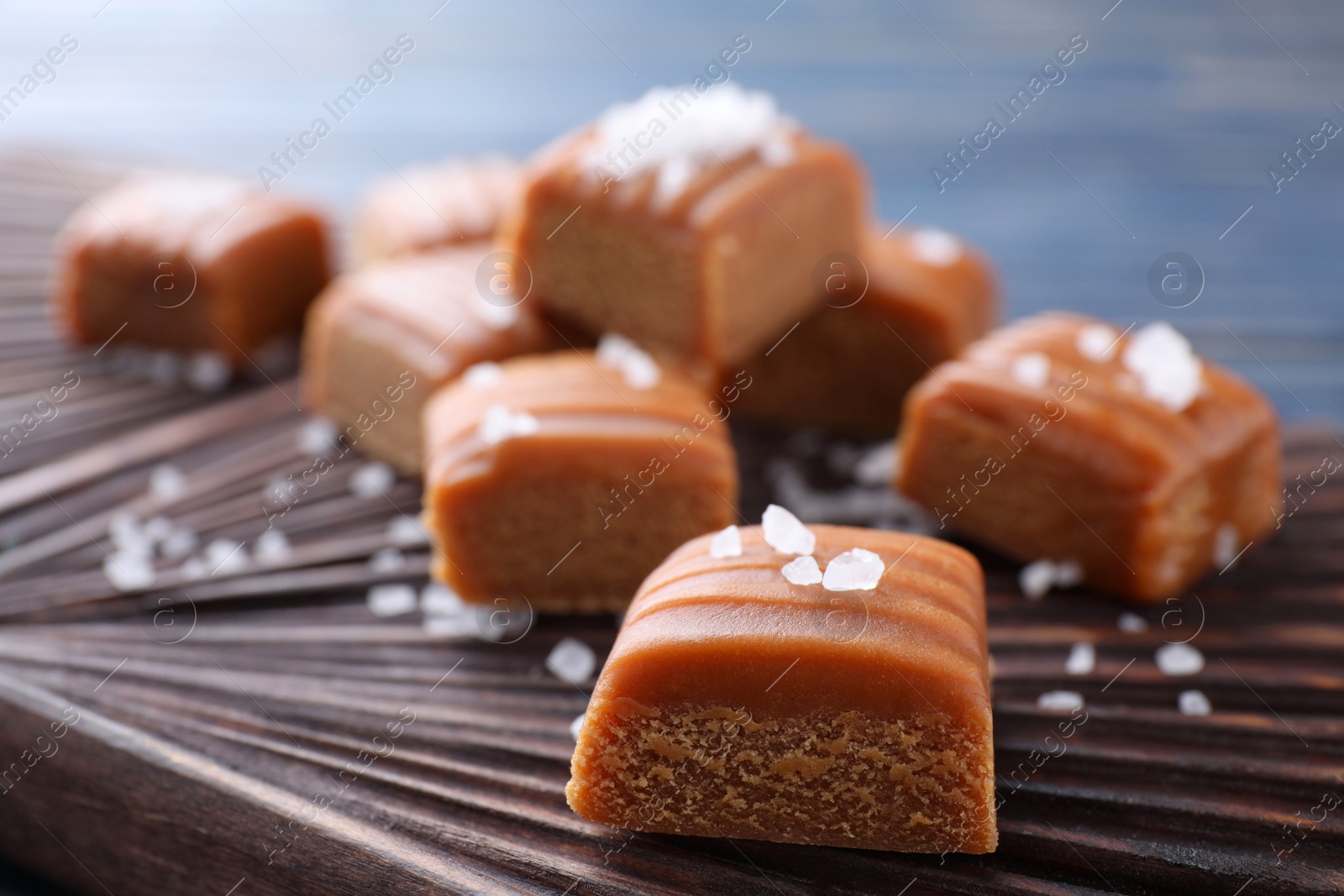 Photo of Delicious salted caramel on board, closeup view