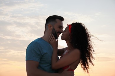 Lovely couple spending time together outdoors at sunset