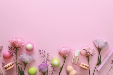 Flat lay composition with flowers and accessories on pink background, space for text. Beauty blogger's workplace