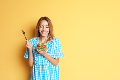Photo of Happy slim woman with salad on color background. Weight loss diet