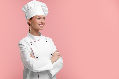 Photo of Young woman chef in uniform on pink background, space for text