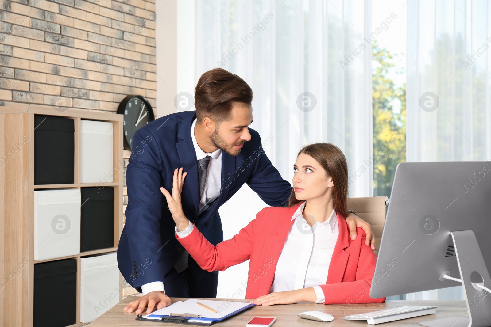 Photo of Boss molesting his female secretary in office. Sexual harassment at work