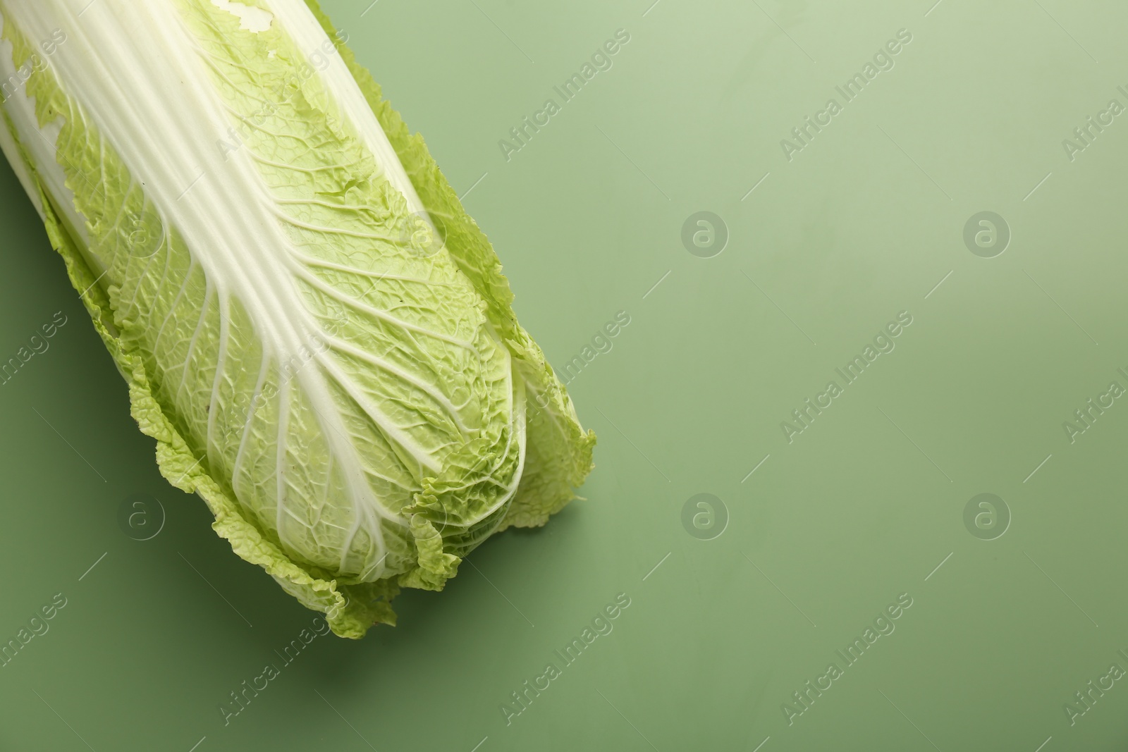 Photo of Fresh ripe Chinese cabbage on pale green background, top view. Space for text