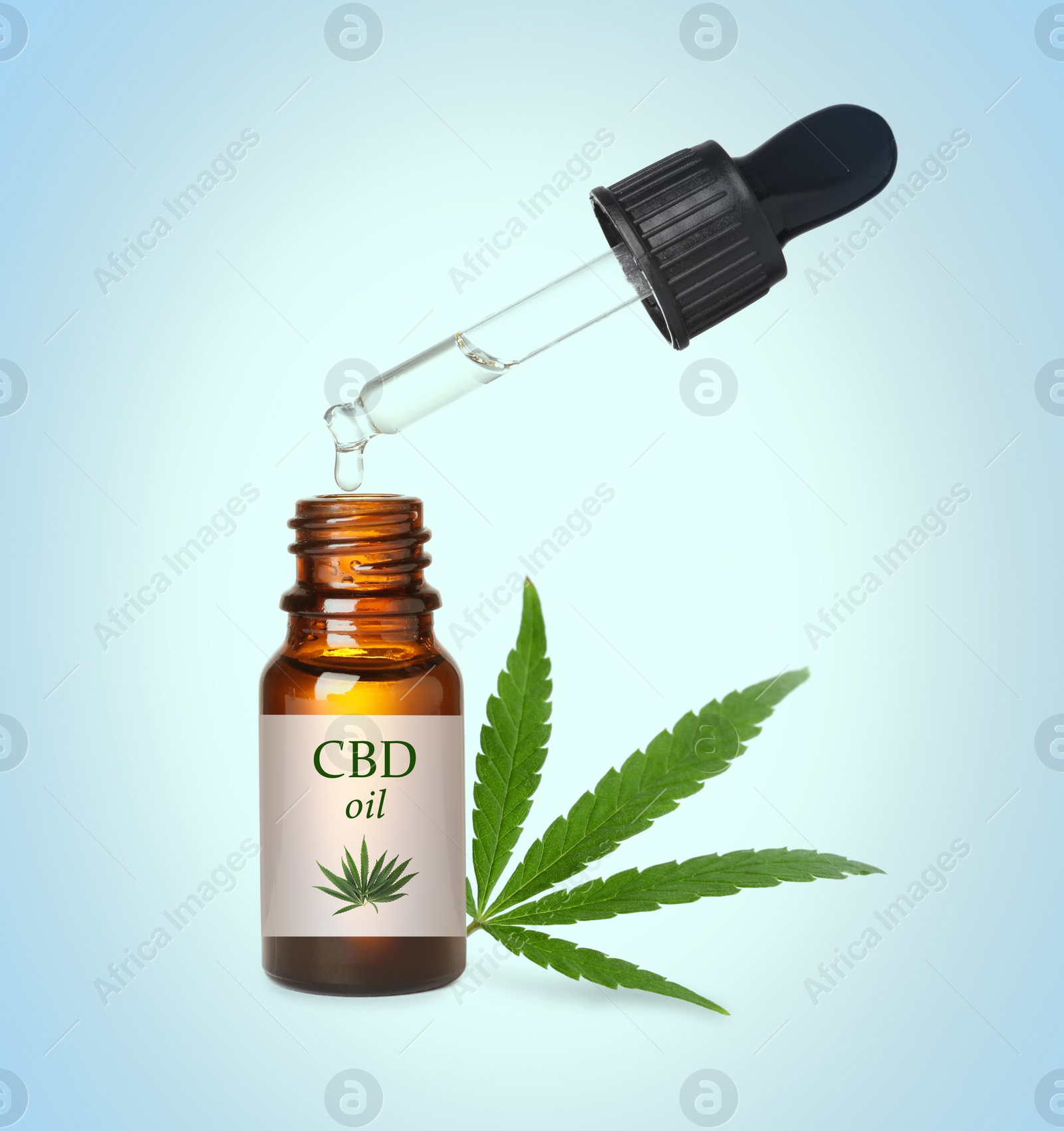 Image of Bottle of cannabidiol tincture and hemp leaf on light blue background