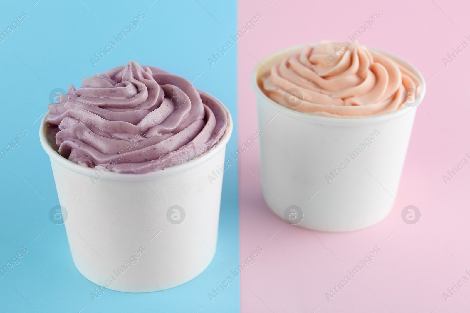 Photo of Cups with tasty frozen yogurts on color background