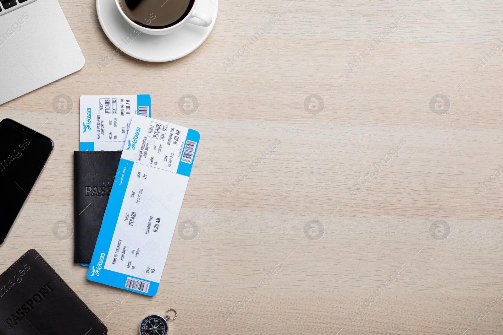 Photo of Flat lay composition with avia tickets and passport on wooden table, space for text. Travel agency concept