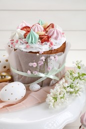 Photo of Traditional Easter cake with meringues and painted eggs on stand