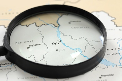 MYKOLAIV, UKRAINE - NOVEMBER 09, 2020: Kyiv city marked on map of Ukraine, view through magnifying glass