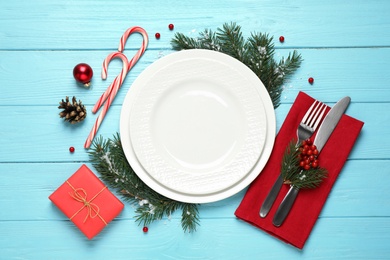 Photo of Christmas table setting on blue wooden background, top view. Space for text